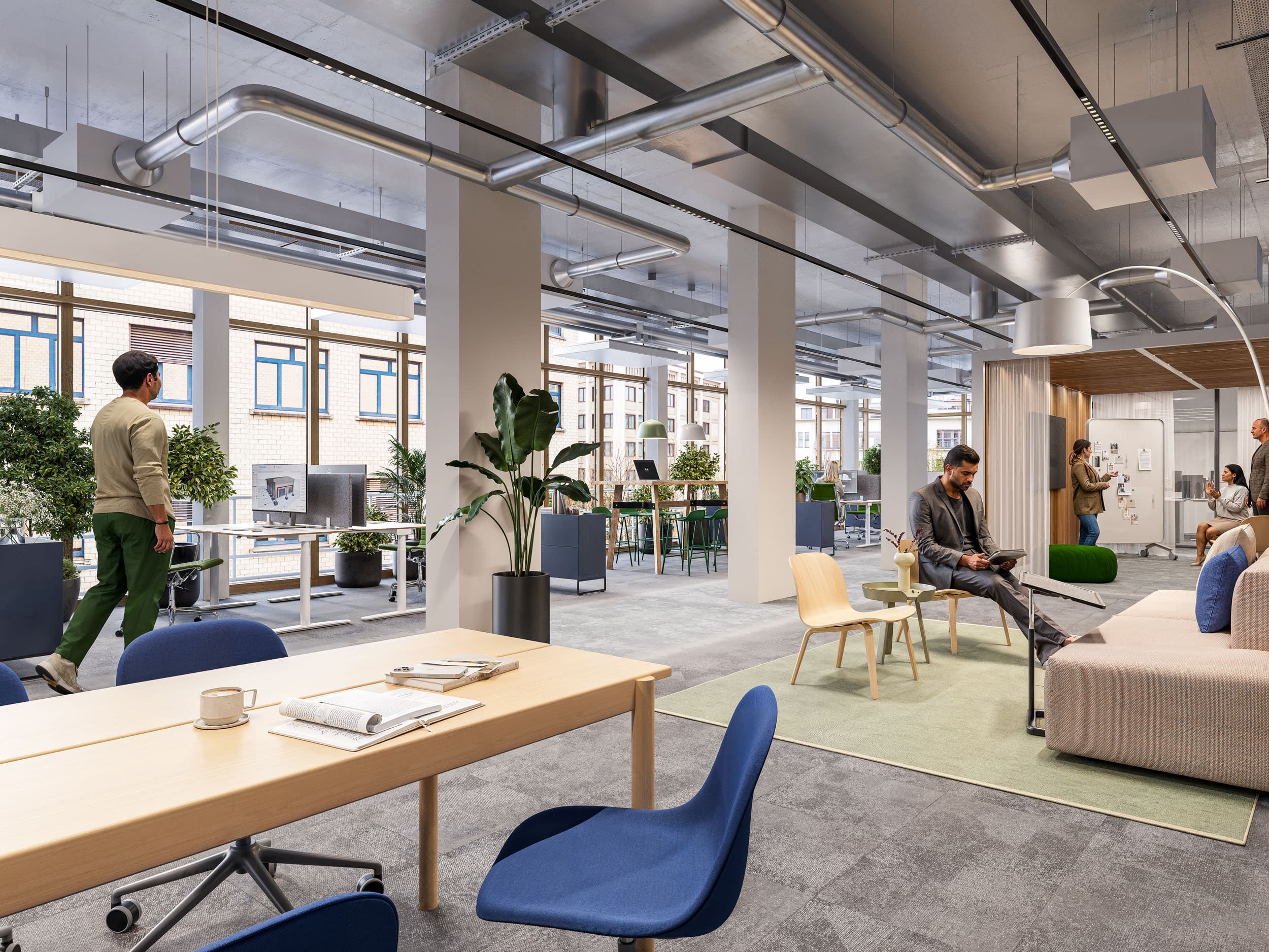Ansicht eines modernen offenen Büroraums im Neuen Klybeck in Basel mit Arbeitstischen und Sitzgelegenheiten
